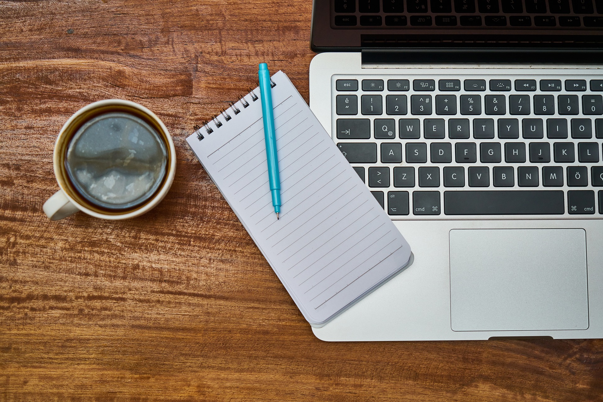 Laptop, coffee and note pad