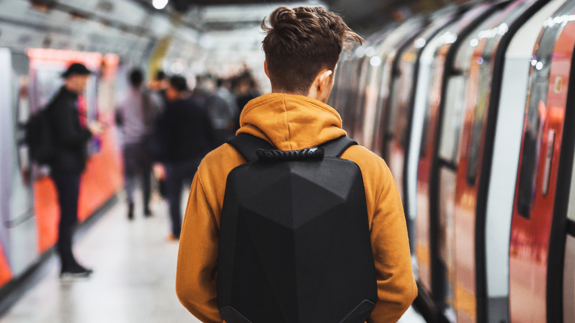 Man on London Underground platform with back to camera